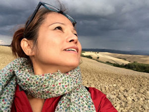 Woman in front of landscape in Tuscany during Walk the Arts art retreat in Italy for all levels