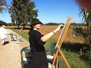 woman painting the landscape with oils during Walk the Arts art workshop and painting retreat in Italy