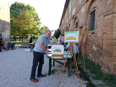 Artist in Tuscany showing his paintings during Walk the Arts art retreats in Italy