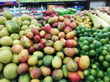 Mangos and limes at a supermarket during Walk the Arts winter escape in South America