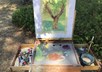A painting of a tree and tubes of paint of a participant of Studio Italia, a top art workshop in Italy by Walk the Arts