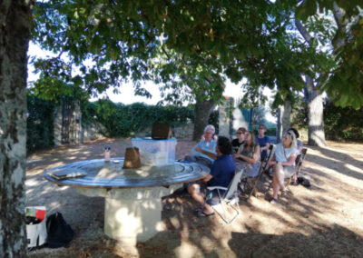 Prof. Yves M. Larocque with a group of students giving a lecture in the garden during Studio Italia, an art workshop in Tuscany