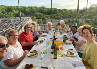 A group of artists having dinner during an art retreat in Provence offered by Walk the Arts